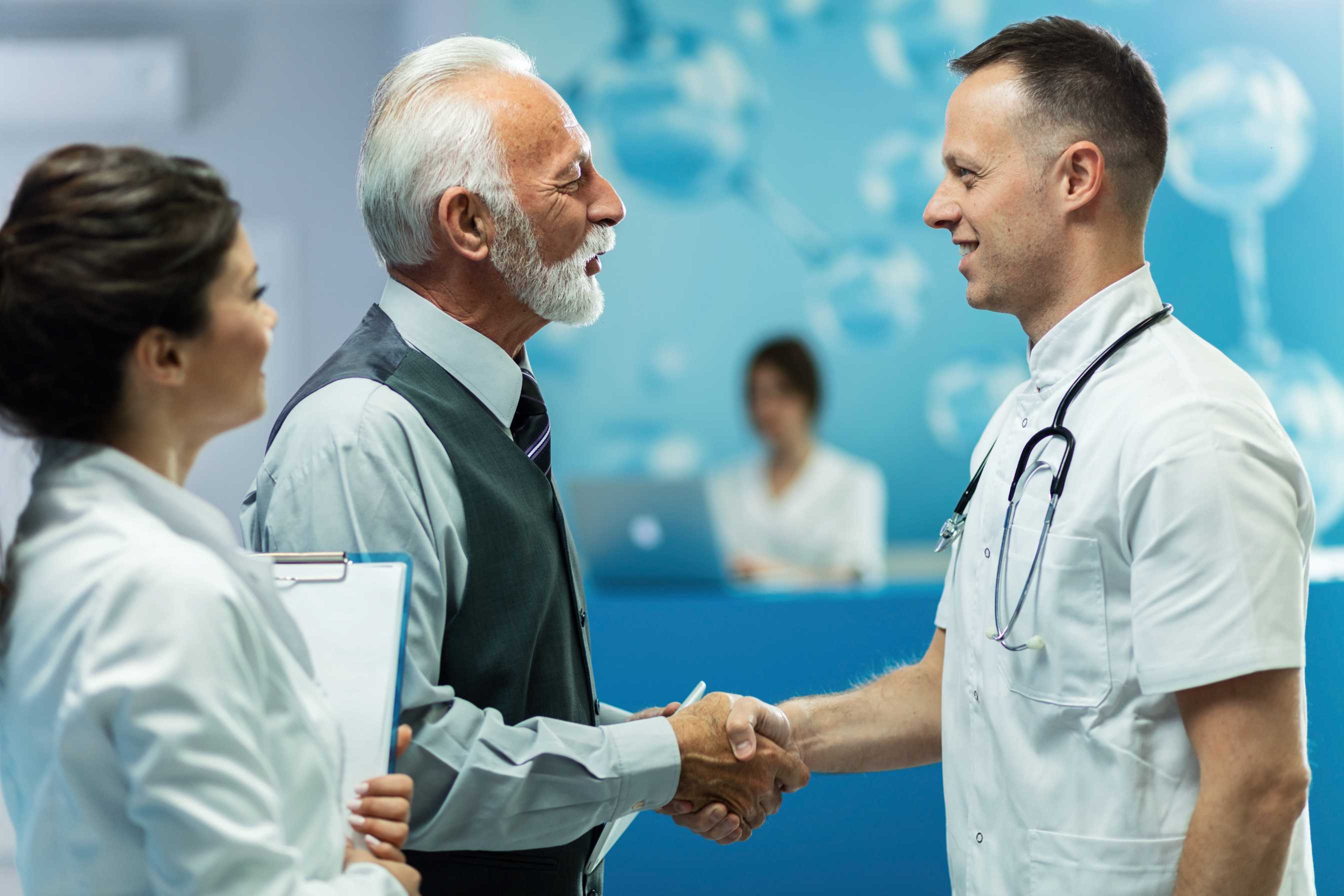 Doctor greeting a patient with a handshake in a clinic